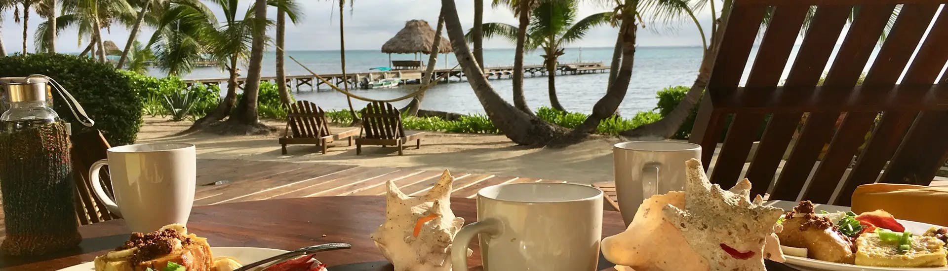 Dining area on beach with drinks overlooking ocean